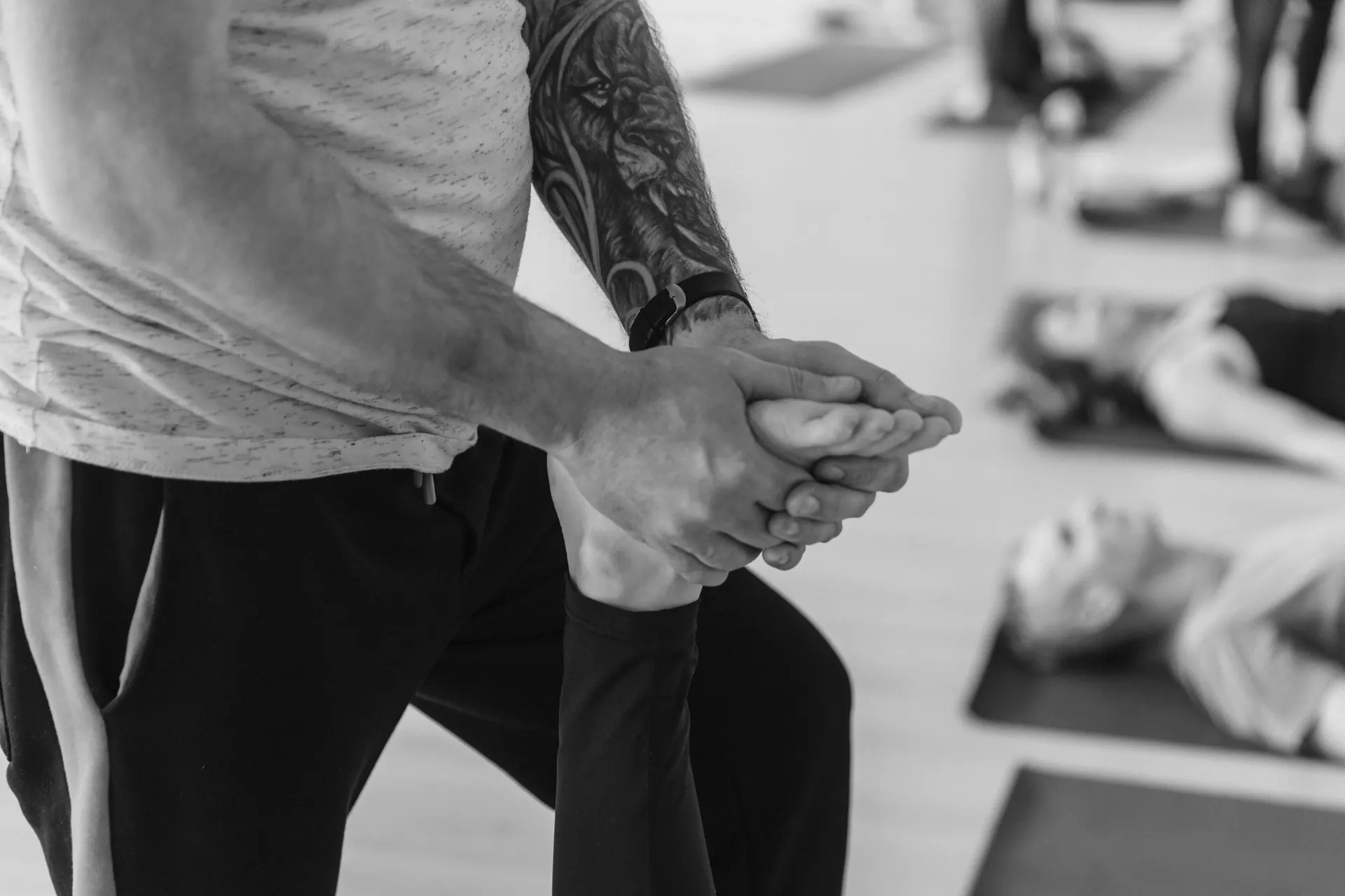 A clinician supporting a patient’s knee during rehabilitation