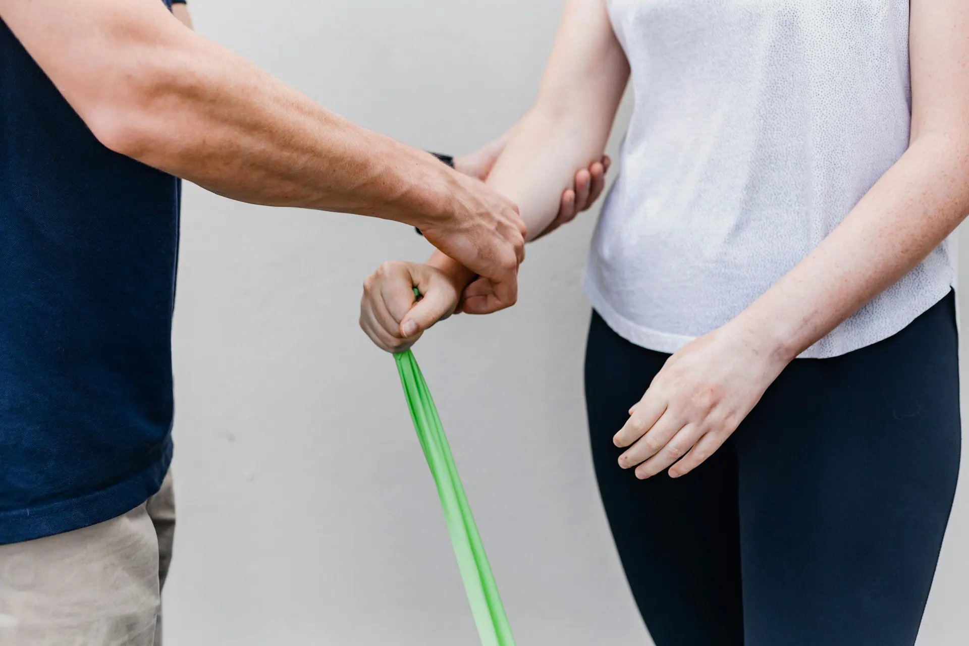 A practitioner guiding a resistance band exercise