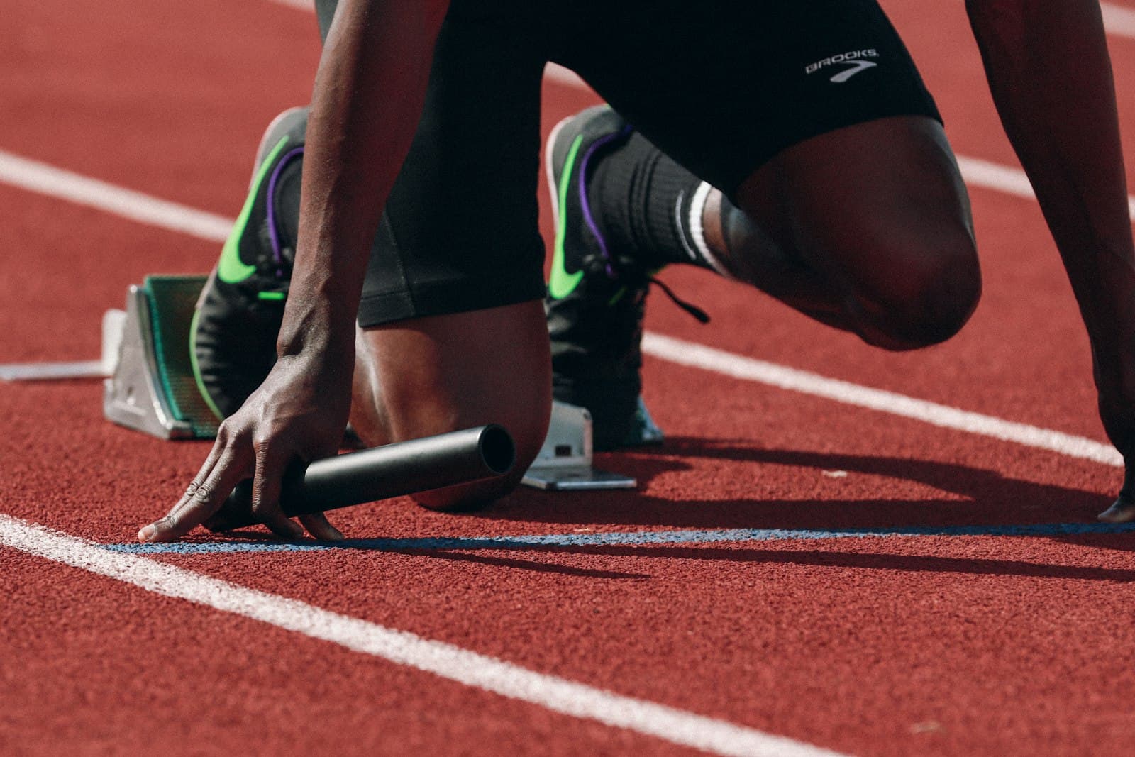 A runner mid-stride on a track